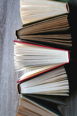 Bunch of vintage hardcover books on wooden background. Top view.