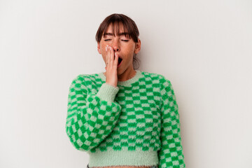 Young Argentinian woman isolated on white background yawning showing a tired gesture covering mouth with hand.