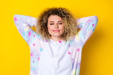 Portrait of attractive cheery dreamy wavy-haired girl in pajama drowsing relaxing isolated over vivid yellow color background - obrazy, fototapety, plakaty