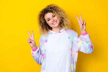 Portrait of attractive cheerful girly wavy-haired girl in pajama showing double v-sign isolated...