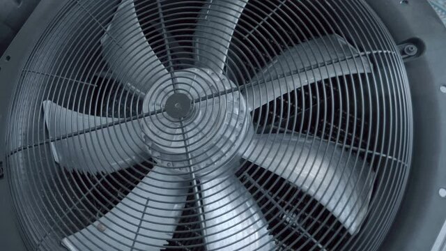 Large, powerful, industrial gray color fan at industrial equipment show, does not rotate. Shot in motion. Closeup