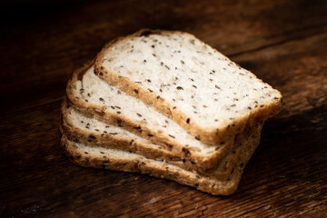Pieces of bread with seeds on a wooden background. Healthy, healthy bread. Healthy food.