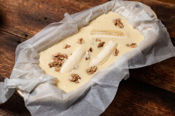 Raw banana bread in the shape. Sweet food. Cooking a banana and walnut muffin. Vegetarian food.