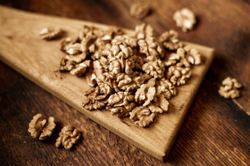 Obraz na płótnie Canvas Peeled walnuts. On a wooden background. Healthy food. Natural background.