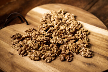 Peeled walnuts. On a wooden board. Healthy food. Natural background.