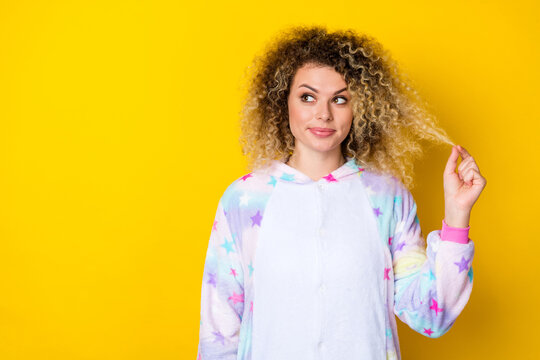 Portrait of attractive cheerful minded funny girly wavy-haired girl ponder copy space isolated over bright yellow color background