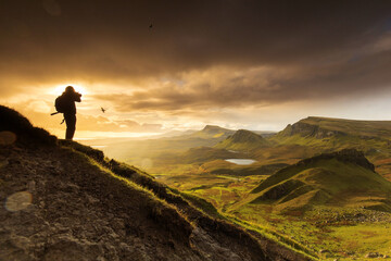 Obraz premium Scenic view of Quiraing mountains in Isle of Skye, Scottish highlands, United Kingdom. Sunrise time with colourful an rayini clouds in background.