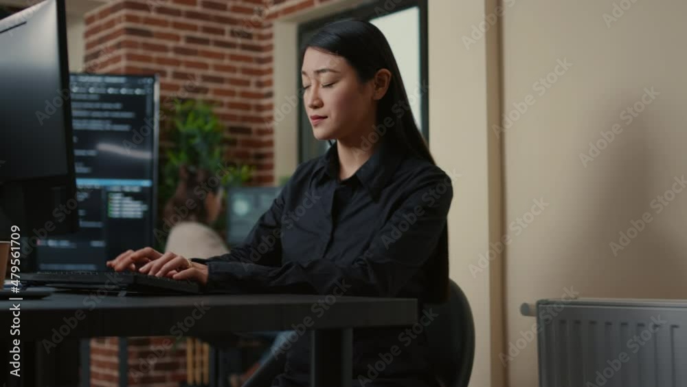 Poster portrait of focused system engineer happy with parsing results sitting at desk in software developme