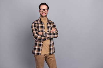 Portrait of attractive content cheerful skilled guy wearing checked shirt copy space folded arms isolated over grey color background