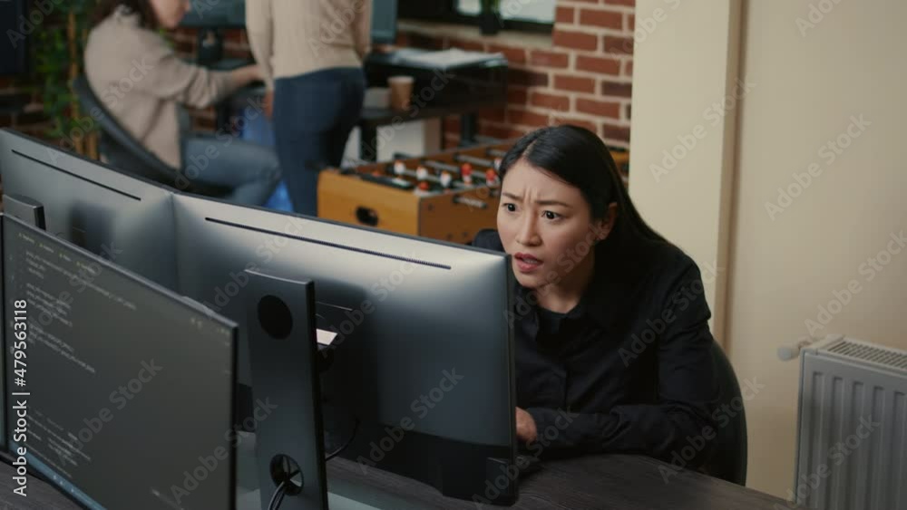 Poster portrait of asian programer focused on writing code encounters unexpected compiling error sitting at