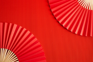 Chinese new year. Red abstract background with hand paper fan for product presentation.