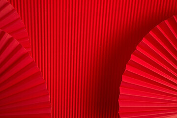 Chinese new year. Red abstract background with hand paper fan for product presentation.