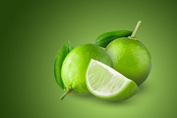 Whole and sliced limes, Sour green fruit isolated on green background.