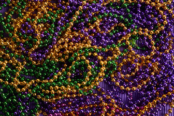 Green, gold, and purple Mardi Gras beads background © vetre