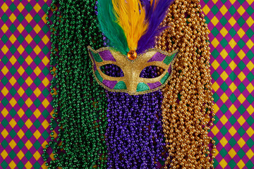 Mardi Gras Mask and colorful Mardi Gras Beads Background © vetre