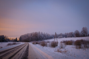 Obraz premium rural landscape tree cloudy morning sunset cold winter with snow and road