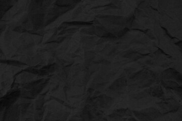 Recycled black creased paper background or cardboard surface from a paper box for packing. crumpled paper concept