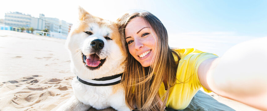 Happy Woman And Dog Taking Selfie Outdoors - Owner Having Enjoying Sunny Day With Its Dog Playing Together Outside - Animals And Human Love