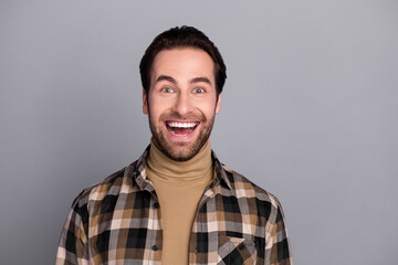 Photo of funny impressed man wear plaid shirt smiling open mouth isolated grey color background