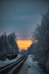 sunrise with clouds cold winter morning with snowy asphalt road