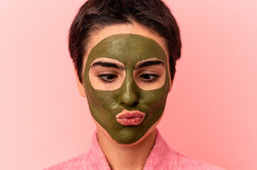 Young caucasian woman wearing a face mask isolated on pink background
