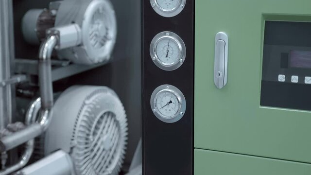 Industrial equipment with gauge showing system pressure and two thermometers showing temperature. Shot in motion. Closeup