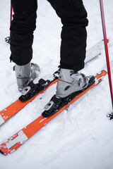 male professional athlete putting on skis for skiing from the mountain close-up