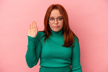 Young caucasian woman isolated on pink background smiling cheerful showing number five with fingers.