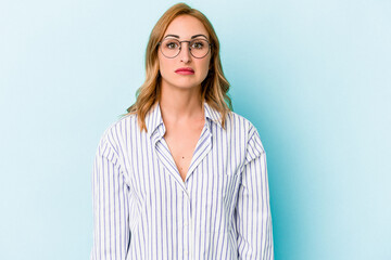 Young caucasian woman isolated on blue background sad, serious face, feeling miserable and...
