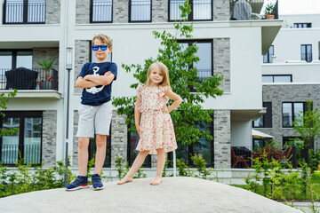 Children at playground in modern new build properties by the water in Offenbach am Main harbor, Hesse