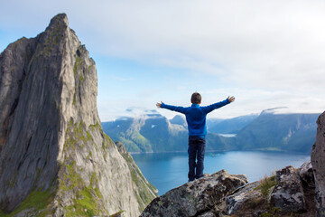 Obraz premium Happy family, standing on a rock and looking over Segla mountain on Senja island, North Norway. Amazing beautiful landscape and splendid nature