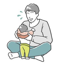困った顔で子どもの着替えを手伝うお父さん