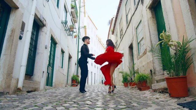 Beautiful Couple Dancing a Latin Dance on the Quiet Street of an Old Town in a City. Sensual Dance by Two Professional Dancers on a Sunny Day Outside in Ancient Culturally Rich Tourist Location.
