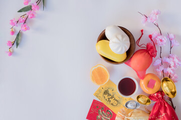 Chinese New Year flat lay white background with assorted festival decorations. Wishing wealth,...
