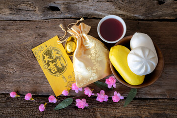Chinese new year festival decorations pow or red packet, orange and gold ingots or golden lump on a...
