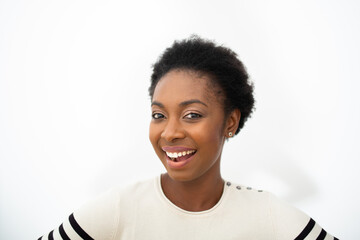 Close up beautiful young African American woman smiling by white isolated background