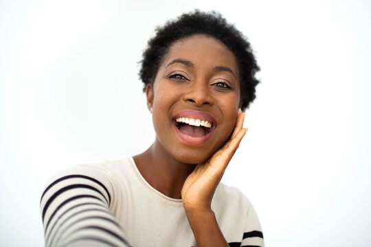 happy young African amercing woman taking selfie with hand to face