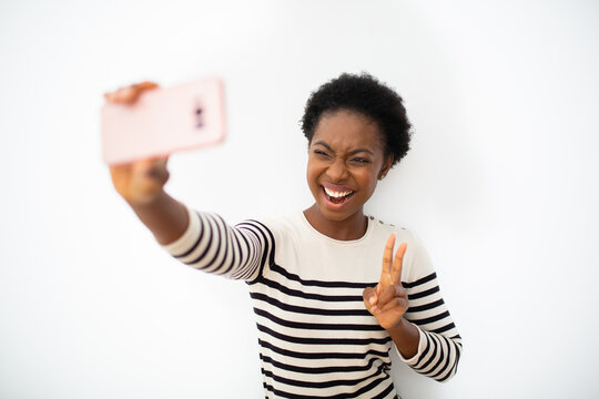 happy young African amercing woman taking selfie with cellphone