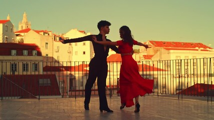 Beautiful Couple Dancing a Latin Dance Outside the City with Old Town in the Background. Sensual Dance by Two Professional Dancers on a Sunset in Ancient Culturally Rich Tourist Location.
