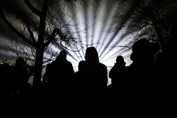 People watch a laser show over the lake during New Years celebrations in the Alexandru Ioan Cuza park in Bucharest.