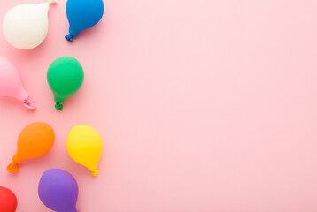 Colorful balloons on light pink table background. Pastel color. Closeup. Empty place for inspirational, positive text, lovely quote or sayings for good mood. Top down view. © fotoduets