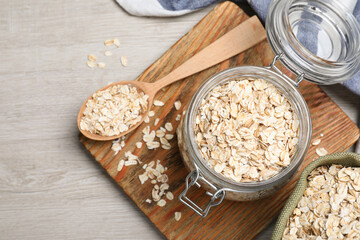 Oatmeal on white wooden table, flat lay