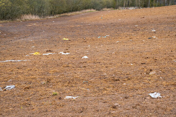 Plastic debris lying in the ground on a field