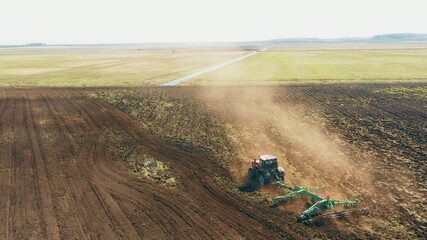 4K Aerial Elevated View.Tractor Plowing Field. Beginning Of Agricultural Spring Season. Cultivator...