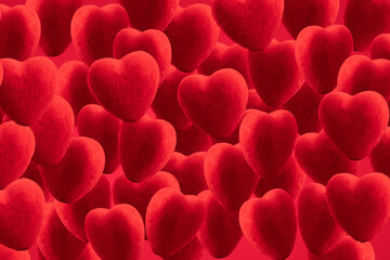 red background of plush hearts. red hearts are a symbol of happy valentine's day, love relationships and weddings