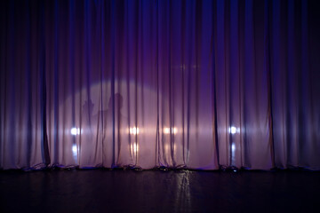 Theatrical background with purple dark curtains and a ray of light.