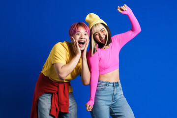 Asian couple with multicolored hair laughing and dancing together