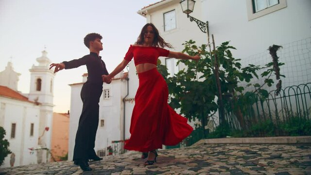 Beautiful Couple Dancing a Latin Dance on the Quiet Street of an Old Town in a City. Sensual Dance by Two Professional Dancers on a Sunny Day Outside in Ancient Culturally Rich Tourist Location.