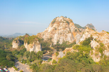 Aerial view of Khao Ngu Stone. National park with river lake, mountain valley hills, and tropical green forest trees at sunset in Ratchaburi, Thailand in travel trip. Natural landscape background.