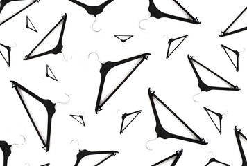Clothes black Hangers Pattern On A White Background. Concept of discounts and promotions